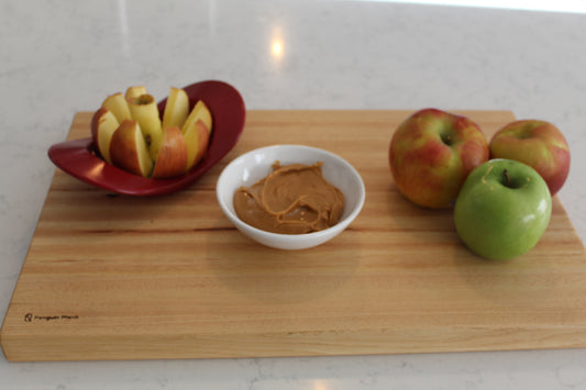 Hickory cutting board with apples and peanut butter.